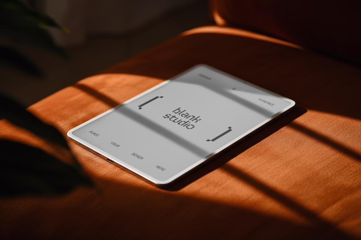 Ipad Mockup on top of Orange Sofa