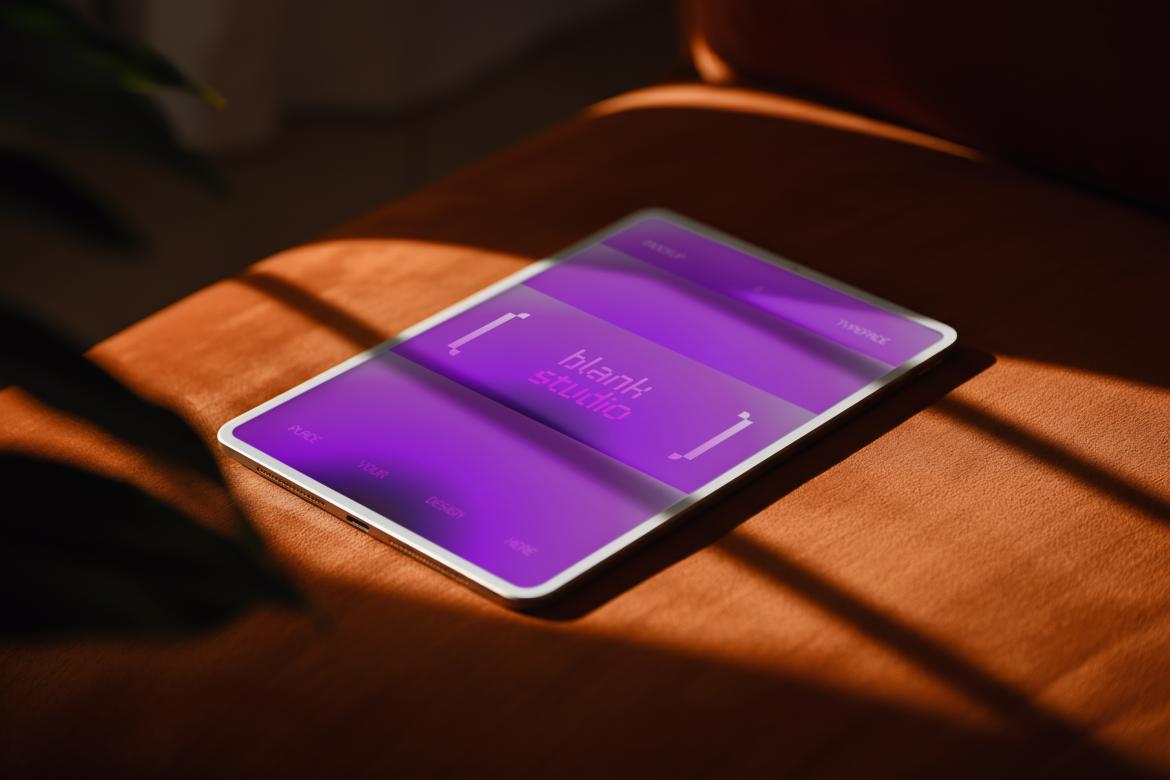 Ipad Mockup on top of Orange Sofa