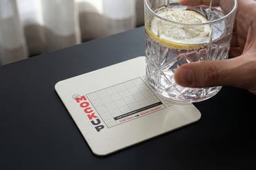 Coaster with Drink and Hand Mockups